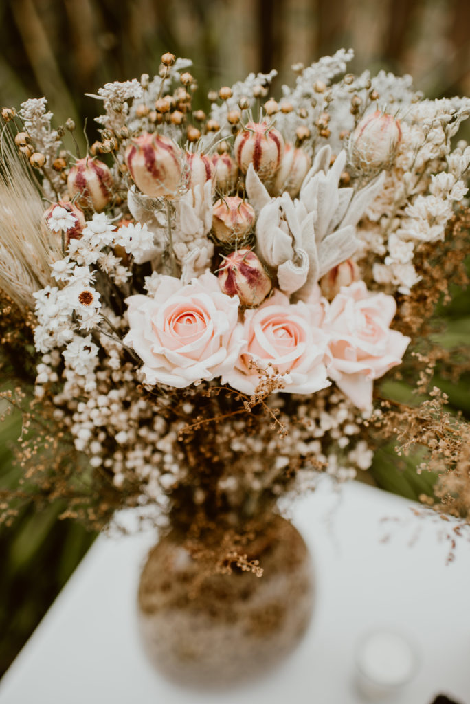 Flowers rest in a vase. Read this post for best practices on how to take care of your wedding flowers.