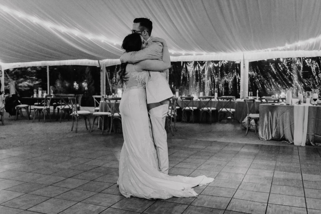 A bride and groom dance together alone at the end of the night. Check out this guide for the best ways to figure out how much wedding photography coverage you need!