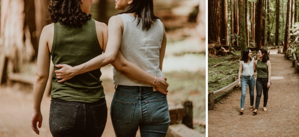 Two women stroll with their arms around each others waists. Be sure to check out this post for photos from their forest and river engagement session!