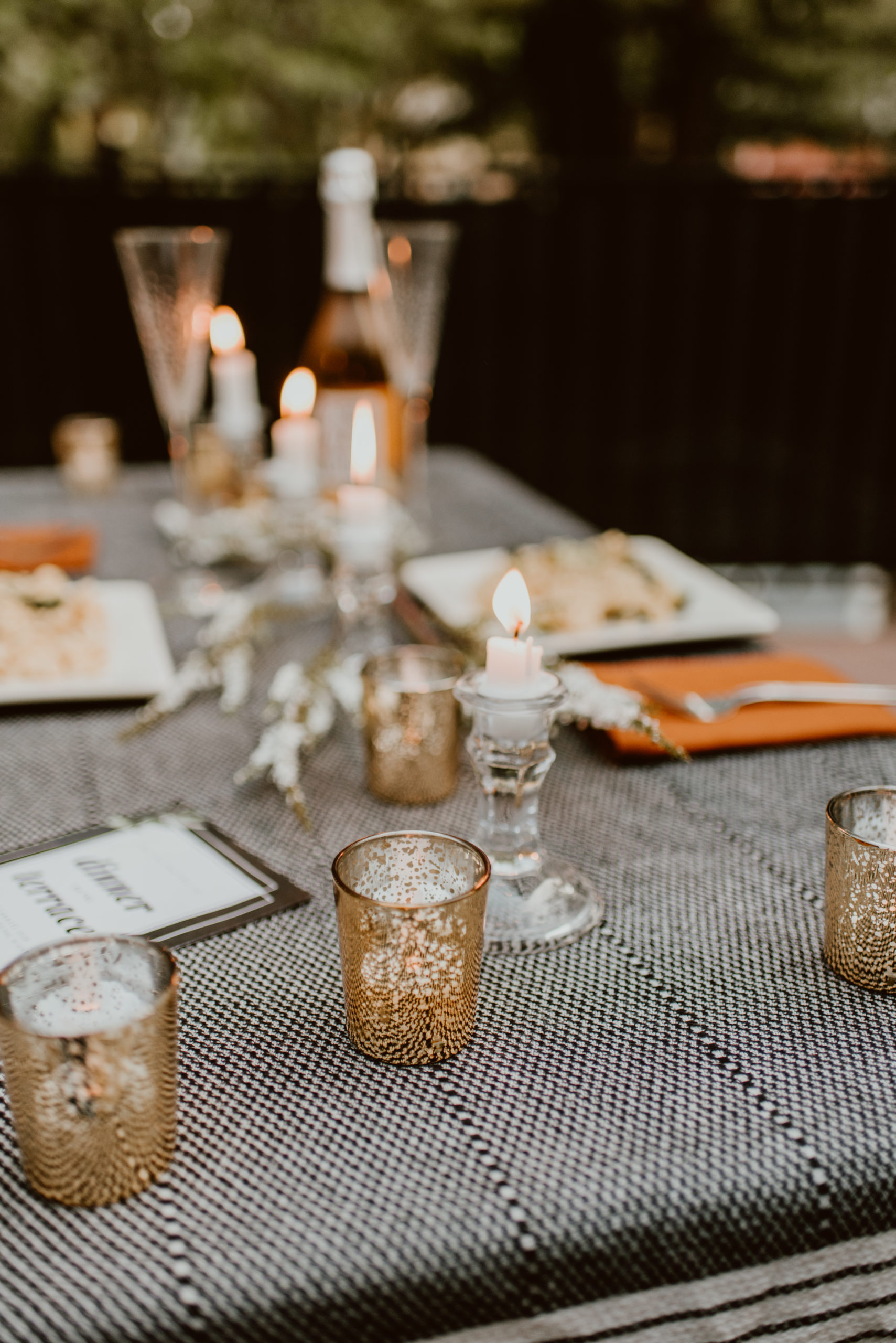 A table is set for two with candles lit. Read this post for an elegant and easy way to celebrate your original wedding date.