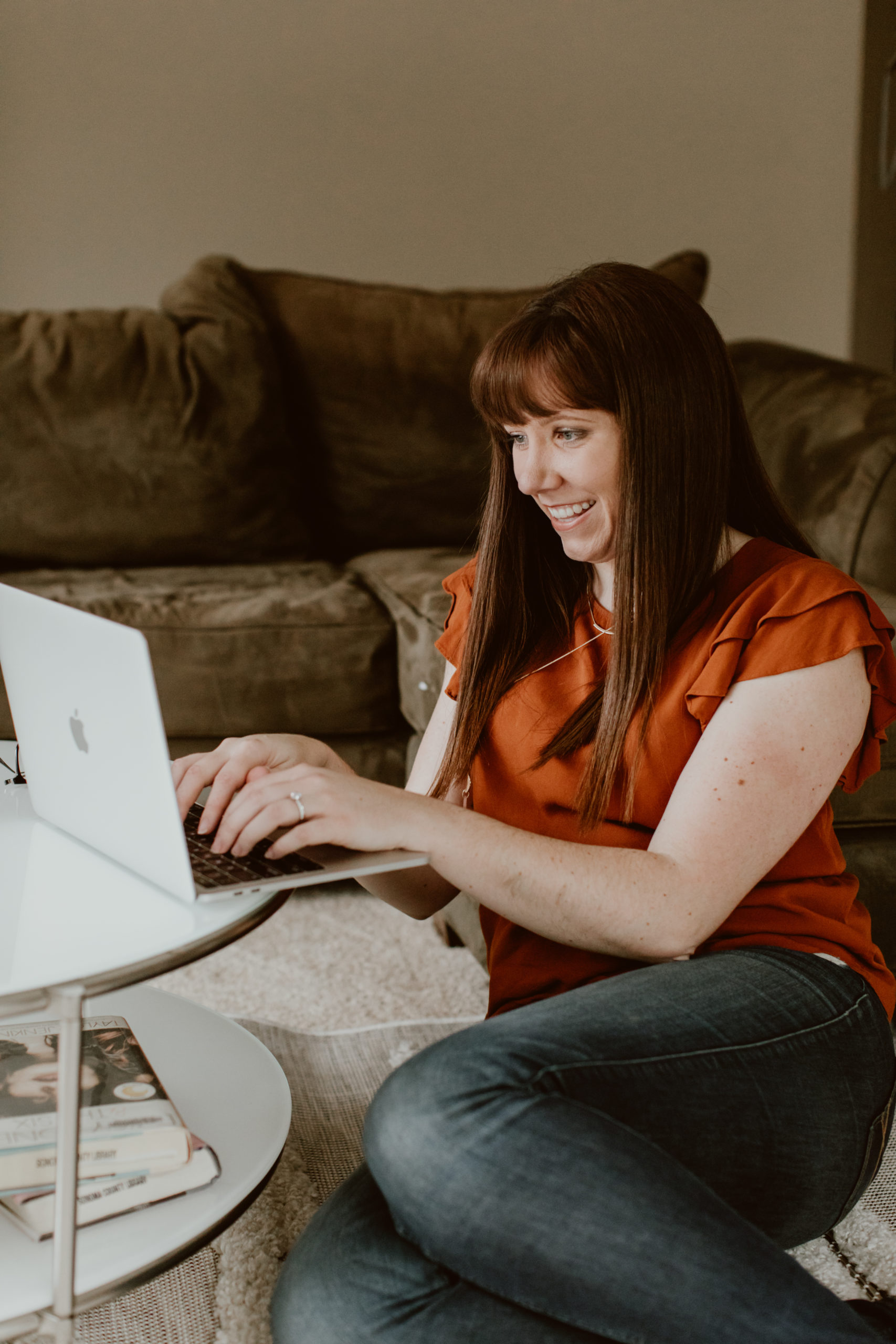A woman sits on the floor and types on a laptop on the coffee table next to her. The transition from my 9-5 to full time entrepreneurship was so exciting -- and I learned a couple of important lessons. Check them out here!
