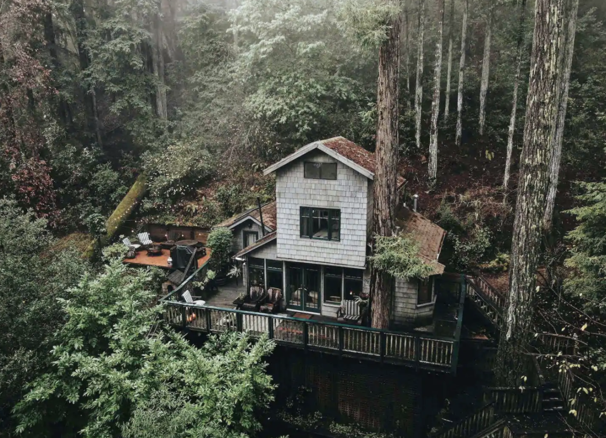 A two story house with a wrap-around deck sits nestled amongst tall trees in the mountains. If you're going to elope in NorCal and still need a place to stay, look no further. Here are nine of my favorite Russian River elopement Airbnb's you won't be able to choose between!