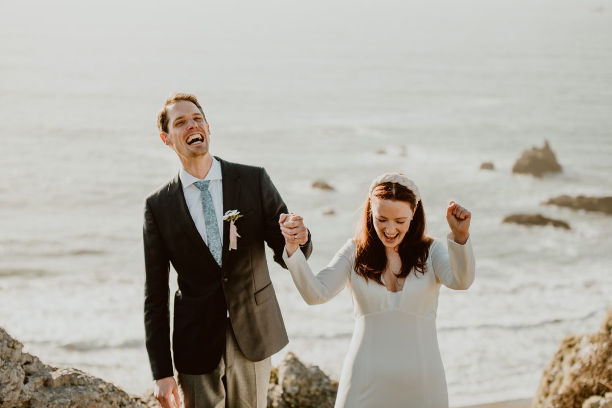 Officially pronounced husband and wife, a couple cheer at the end of  their wedding ceremony on the Sonoma coast.